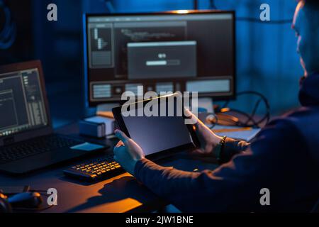 hacker using tablet pc computer for cyber attack Stock Photo