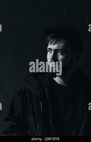 young man looks away, black and white photo Stock Photo