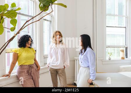 Multiracial female entrepreneurs planning strategy in creative office