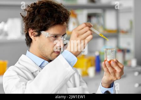 male scientist with chemical working in laboratory Stock Photo