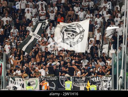 Turin, Italy, 31st August 2022. Spezia fans wave giant flags and cheer on their team during the Serie A match at Allianz Stadium, Turin. Picture credit should read: Jonathan Moscrop / Sportimage Stock Photo