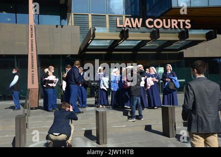 CHRISTCHURCH, NEW ZEALAND, AUGUST 29, 2022: Members of the Gloriavale Christian Community speak to the press outside the Justice Precinct building in Christchurch where a hearing was underway over the employment status of women in the community. Stock Photo