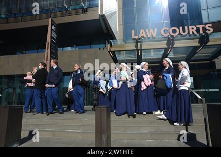 CHRISTCHURCH, NEW ZEALAND, AUGUST 29, 2022: Members of the Gloriavale Christian Community gather outside the Justice Precinct building in Christchurch where a hearing was underway over the employment status of women in the community. Stock Photo