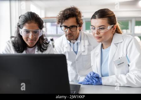 scientists with laptop working in laboratory Stock Photo