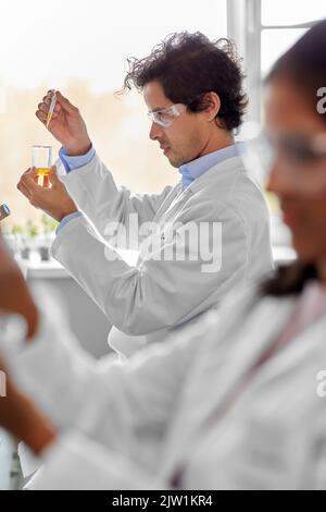 male scientist with chemical working in laboratory Stock Photo