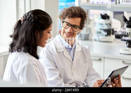 scientists with tablet pc working in laboratory Stock Photo