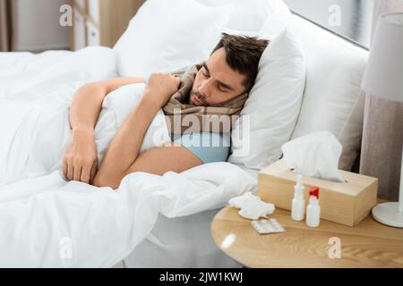 sick man sleeping in bed at home Stock Photo