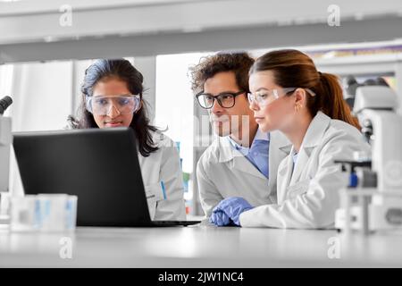 scientists with laptop working in laboratory Stock Photo