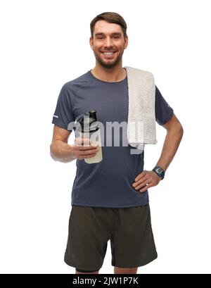 happy man in sports clothes with bottle and towel Stock Photo