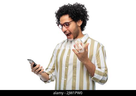 surprised young man with smartphone Stock Photo