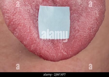 lsd mark on tongue closeup, psychedelic drug trip. Stock Photo