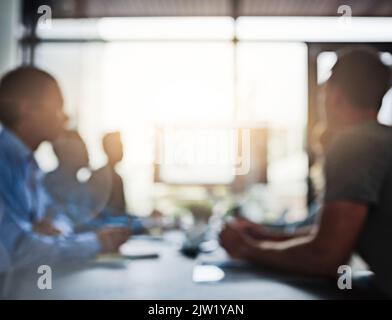 Working together to ensure success. businesspeople having a meeting in an office. Stock Photo