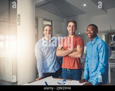 Theyre the dream team. Portrait of three architects standing in an office. Stock Photo