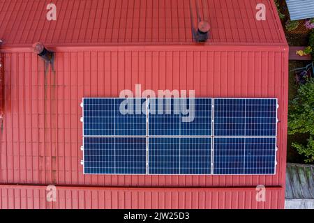 New photovoltaic solar panels on red roof Stock Photo