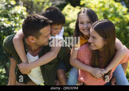 Caucasian family spending time in their garden together Stock Photo