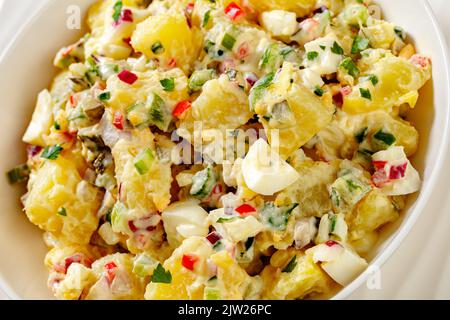 close-up of shout hallelujah potato salad with pickles, celery, eggs, jalapeno and mayonnaise dressing in white bowl Stock Photo