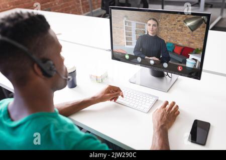 African american businessman discussing on video conference with caucasian businesswoman in office Stock Photo
