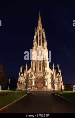 Illuminated night image of The First Church of Otago - Dunedin New Zealand. This decorated Gothic Style church is located in central Dunedin as opened Stock Photo