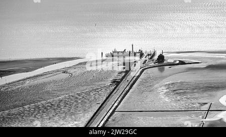 Pellworm ferry pier backlit, sunlight glistening on the sea, black and white photo, aerial view, Pellworm Island, North Frisia, Schleswig-Holstein Stock Photo