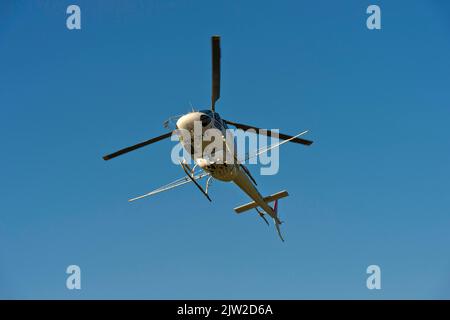 Helicopter Eurocopter AS350 B2 Ecureuil of Air-Glaciers SA with mounted spraying rods in flight, Leytron, Valais, Switzerland Stock Photo