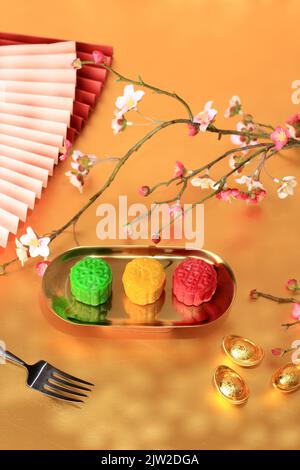Colorful Snow Skin Moon Cake, Sweet Mochi Mooncake, Traditional Chinese Dessert for Mid-Autumn Festival. On Gold Plate Stock Photo