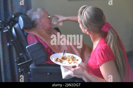 Help with food intake or taking medication, care and support for senior citizens in Arbeiterwohlfahrt (AWO) senior citizens' centre, Germany Stock Photo