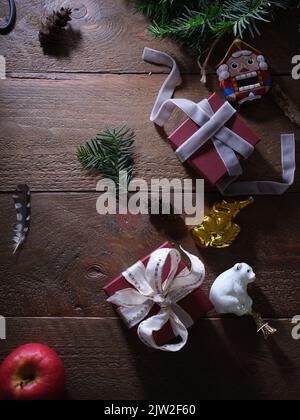Christmas flatlay with decoration, fir branch and gifts. Top view with copy space. Vintage christmas balls, rustic background. Stock Photo
