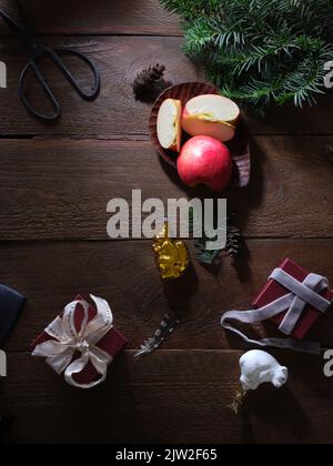 Christmas flatlay with decoration, fir branch and gifts. Top view with copy space. Vintage christmas balls, rustic background. Stock Photo