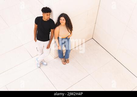 From above full length of young couple looking away while standing together Stock Photo