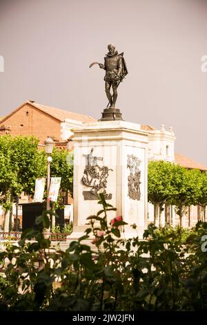 Alcala de Henares, Spain - June 18, 2022: Statue of Miguel de Cervantes and sub-scenes of his most famous novel The Quixote in the center of the squar Stock Photo