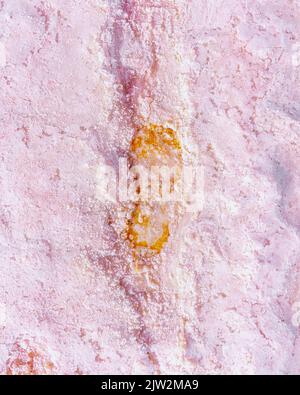 Full frame textured background of rough surface of natural pink marble wall with golden inclusion Stock Photo