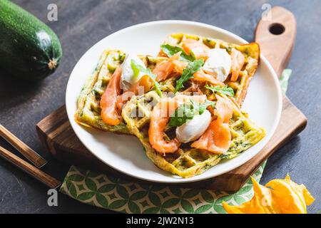 Belgian waffles with zucchini and greens with cottage cheese and salted salmon. Stock Photo