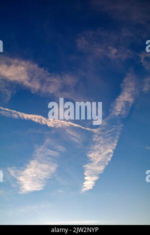 Contrail against a blue sky Stock Photo