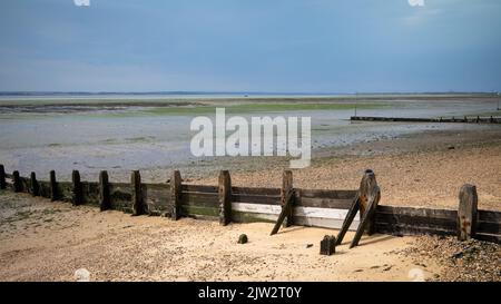 A wooden groyne at low tide on the beach at Chalkwell, near Southend-on-Sea in Essex, UK.