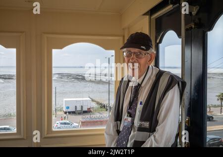 A volunteer operator on the Cliff Lift, a funicular railway in Southend-on-Sea, Essex, UK. The Cliff Lift opened in 1912. Stock Photo