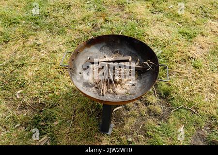A fire pit with wood and kindling ready to be lit on a farm Stock Photo