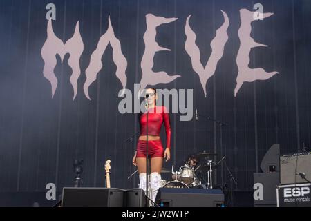 Maeve singing wearing a red top and shorts Stock Photo