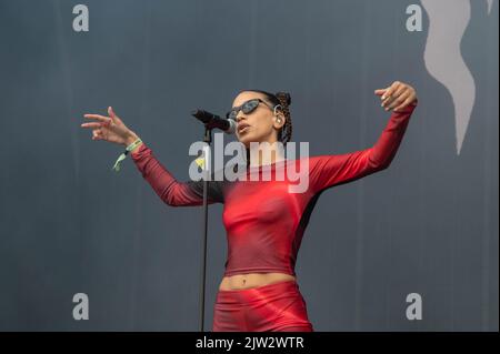 Maeve singing wearing a red top and shorts Stock Photo