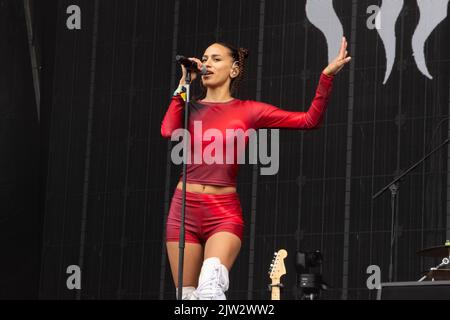 Maeve singing wearing a red top and shorts Stock Photo