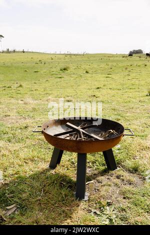 A fire pit with wood and kindling ready to be lit on a farm Stock Photo