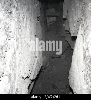 1960s, historical, inside an old, abandoned mine shaft, showing the ...