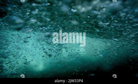 Under water bubble. Playing in the surf to capture bubbles rising to the surface. Stock Photo