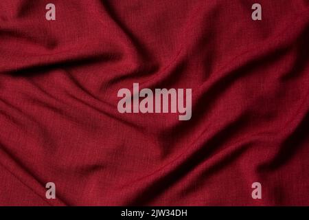 Red crumpled linen fabric texture background. Natural linen organic eco textiles canvas background. Top view Stock Photo