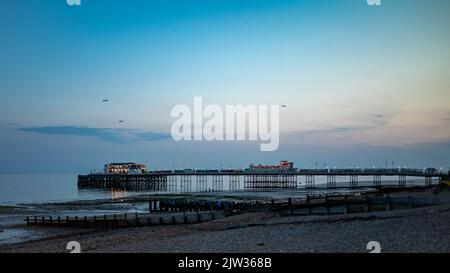 Worthing Pier in West Sussex, UK, seen at dusk on a summer's evening. Stock Photo