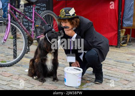 Bridport, Dorset, UK.  3rd September 2022.   Festival-goer and her dog at the Bridport Hat festival in Dorset  Picture Credit: Graham Hunt/Alamy Live News Stock Photo