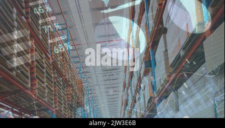 Image of financial data and graphs over warehouse Stock Photo