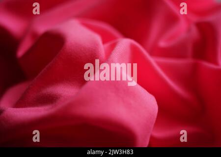 Closeup wrinkled pink jersey, soft fabric background. Stock Photo