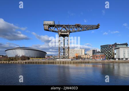 The OVO Hydro, Scottish Event Campus, Finnieston crane and Rotunda viewed from the opposite bank of the river Clyde in Glasgow, Scotland, UK