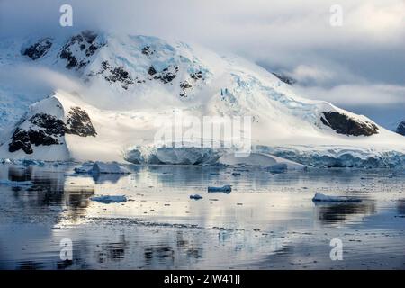 Landscape in Antarctica, Paradise Harbour aka Paradise Bay. Argentine owned station, Base Brown aka Brown Station.   Melting of the poles. Antarctica Stock Photo