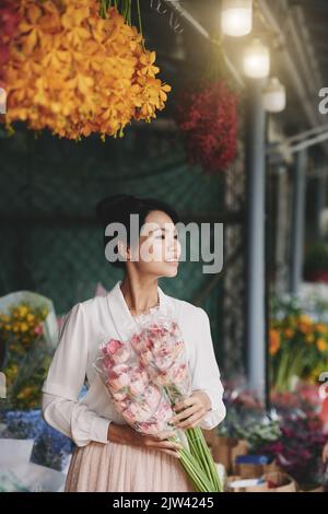 Attractive Asian woman working in her flower shop Stock Photo